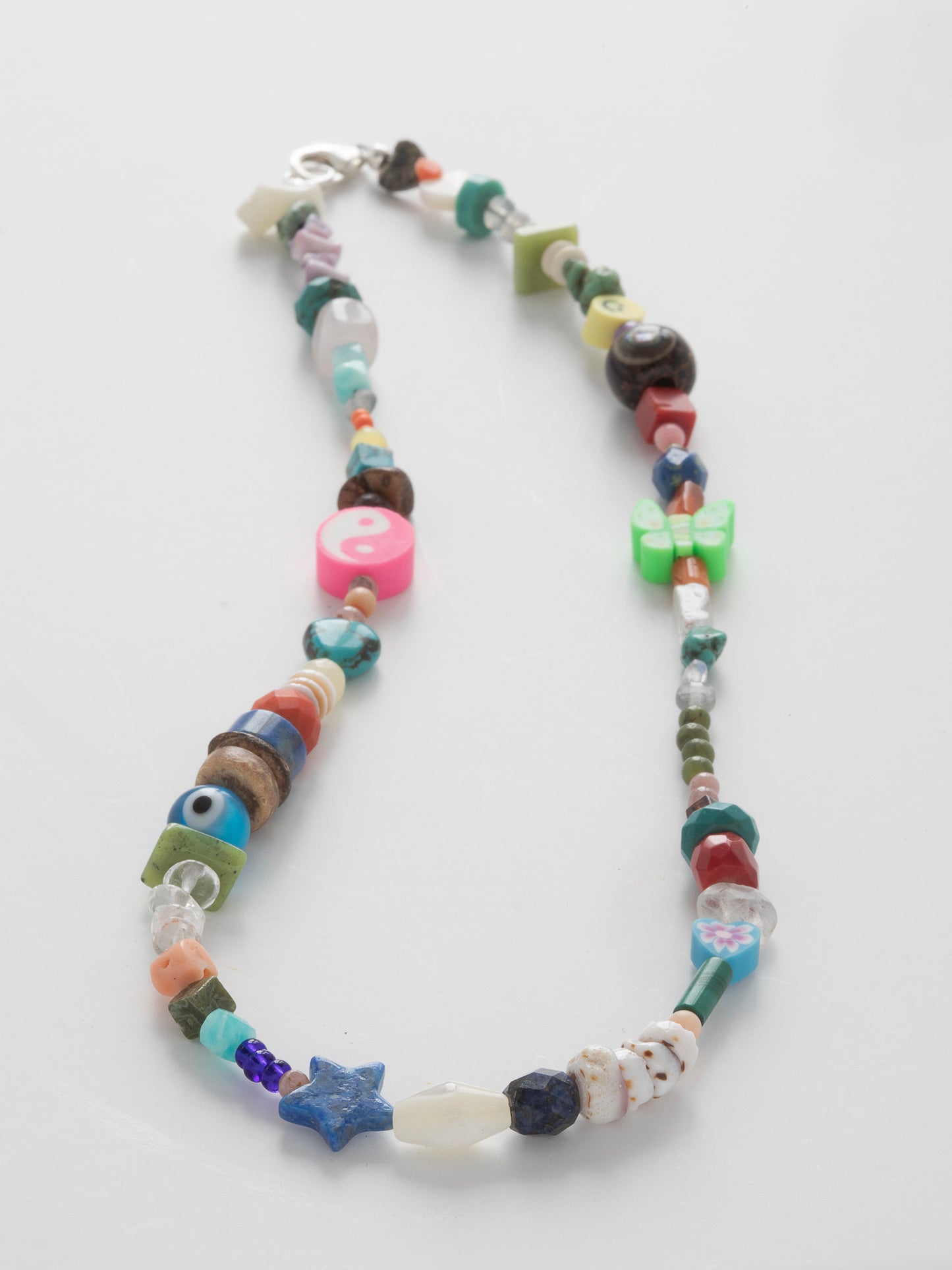 Anse Noire Necklace (#064), Abalone, Amethyst, Amazonite, Apatite, Black Lava Rock, Blue Lapis, Carnelian, Citrine, Coconut Shells, Green Jade, Howlite, Labradorite, Malachite, Moonstone, Mother of Pearl, Natural Shells, Peridot, Pink Coral, Purple Fluorite, Red Coral, Rhodonite, Rose Quartz, Serpentine, Turquoise, Sterling Silver clasp, One-of-a-kind, Designed & handmade in California.