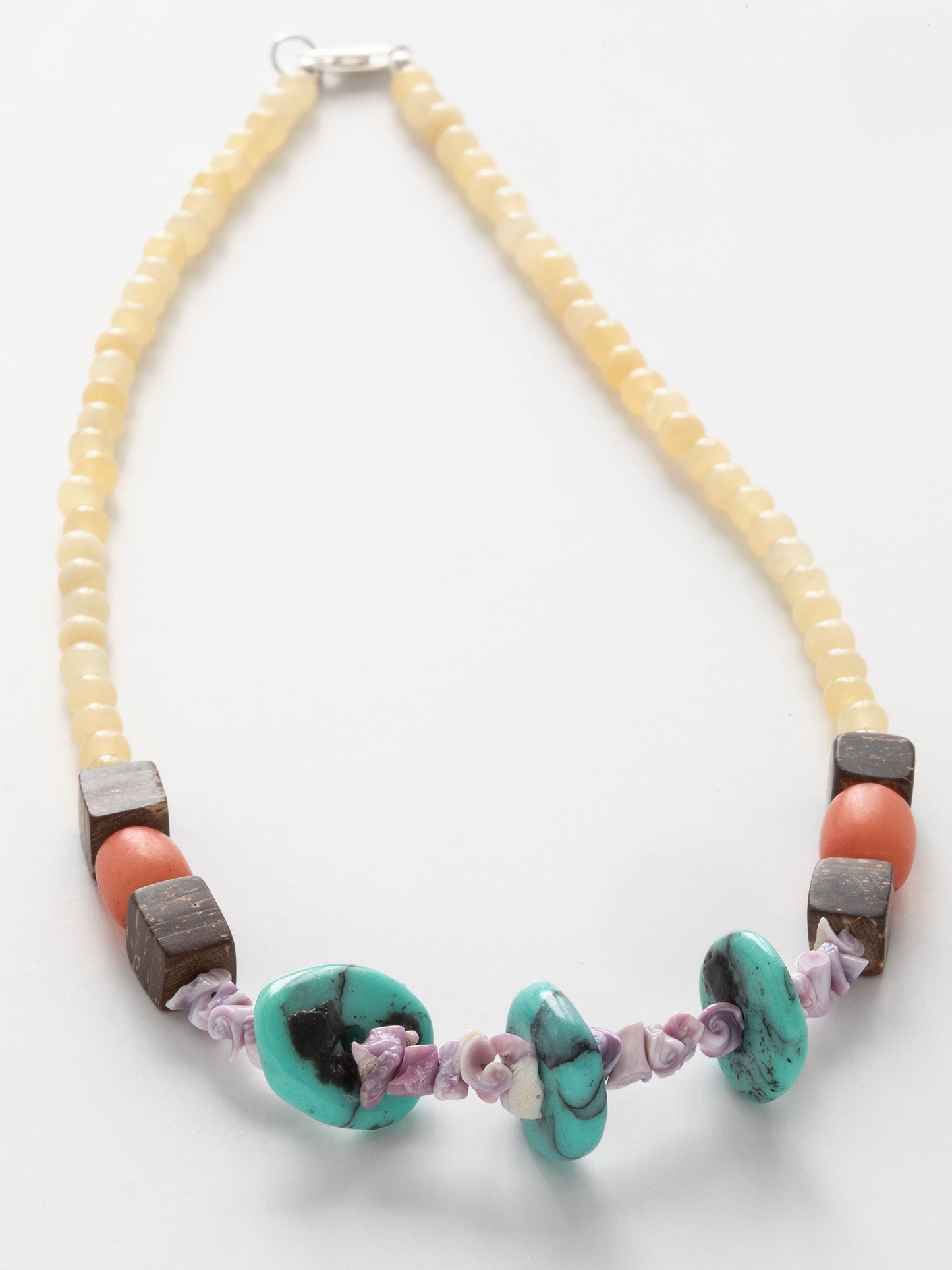 San Juan del Sur Necklace, Buri Seeds, Citrine, Coconut Shells, Natural Shells, Turquoise, Sterling Silver clasp, One-of-a-kind, Designed & handmade in California. The lavender-hued spirals of Natural Shells represent the beautiful journey of life, while cubes of Coconut Shells symbolize the Sacred Geometry that lives all around us. Yellow Citrine calls to abundance & wealth, & it is believed Turquoise can act as a source of protection. Unifies the Solar Plexus & Throat Chakras.