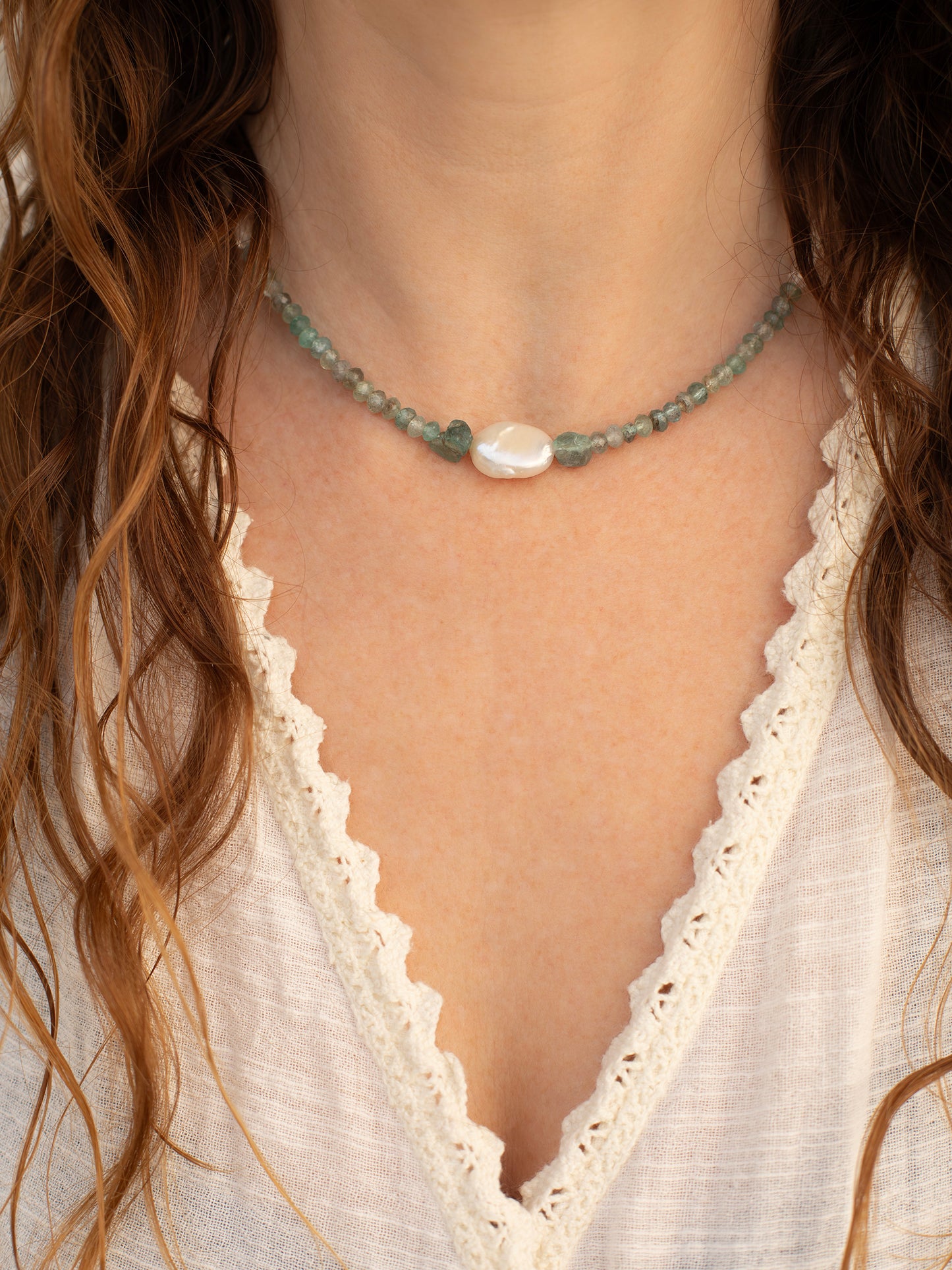 One-of-a-kind statement choker necklace lovingly designed & handmade in California with Apatite, Aquamarine, Freshwater Pearl, Quartz, & Sterling Silver clasp. Rooted in encouraging holistic energy, this necklace is designed to unite the Sacral, Solar Plexus, Heart, Throat, Third Eye, & Crown Chakras.