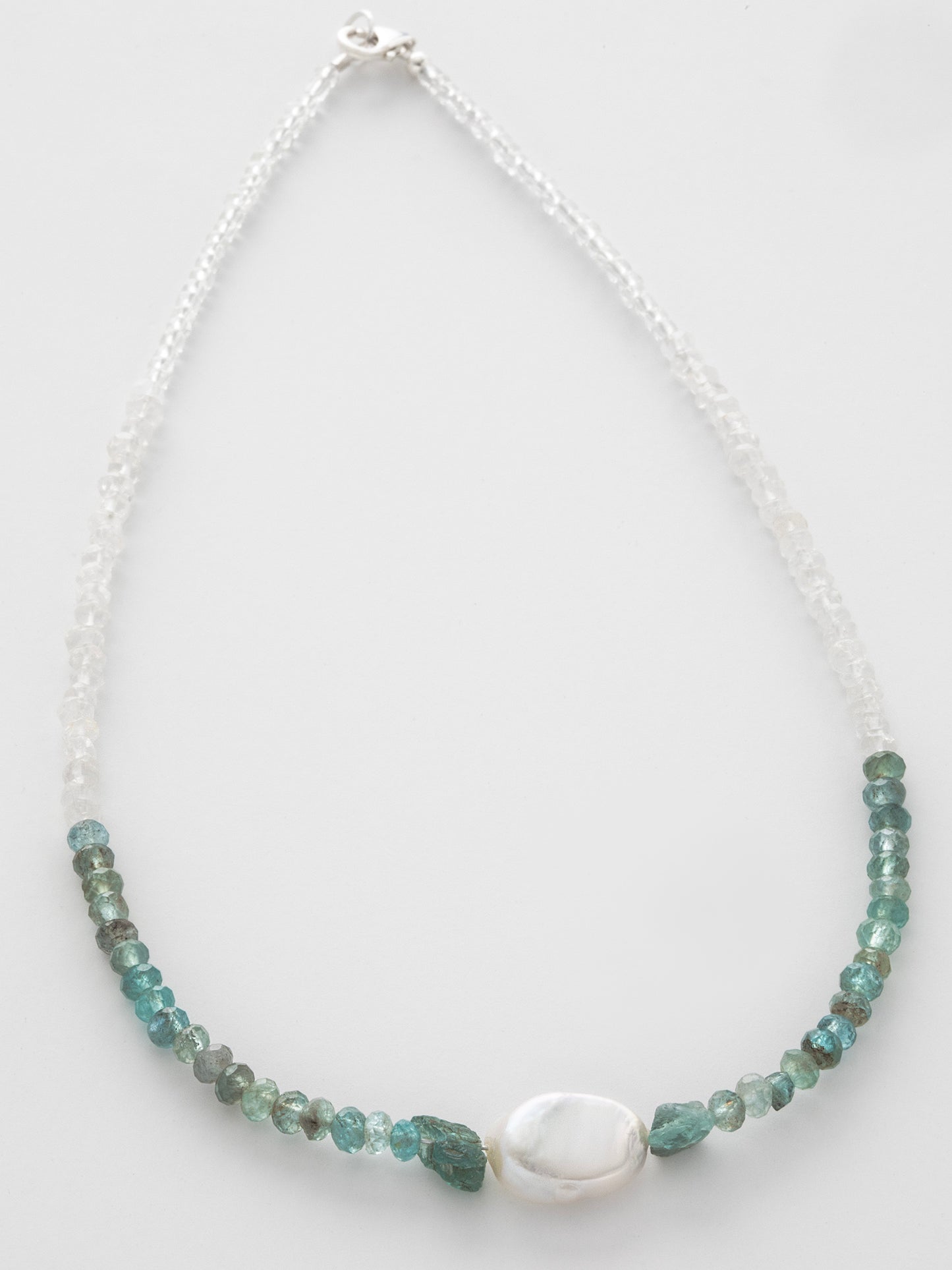 One-of-a-kind statement choker necklace lovingly designed & handmade in California with Apatite, Aquamarine, Freshwater Pearl, Quartz, & Sterling Silver clasp. Rooted in encouraging holistic energy, this necklace is designed to unite the Sacral, Solar Plexus, Heart, Throat, Third Eye, & Crown Chakras.