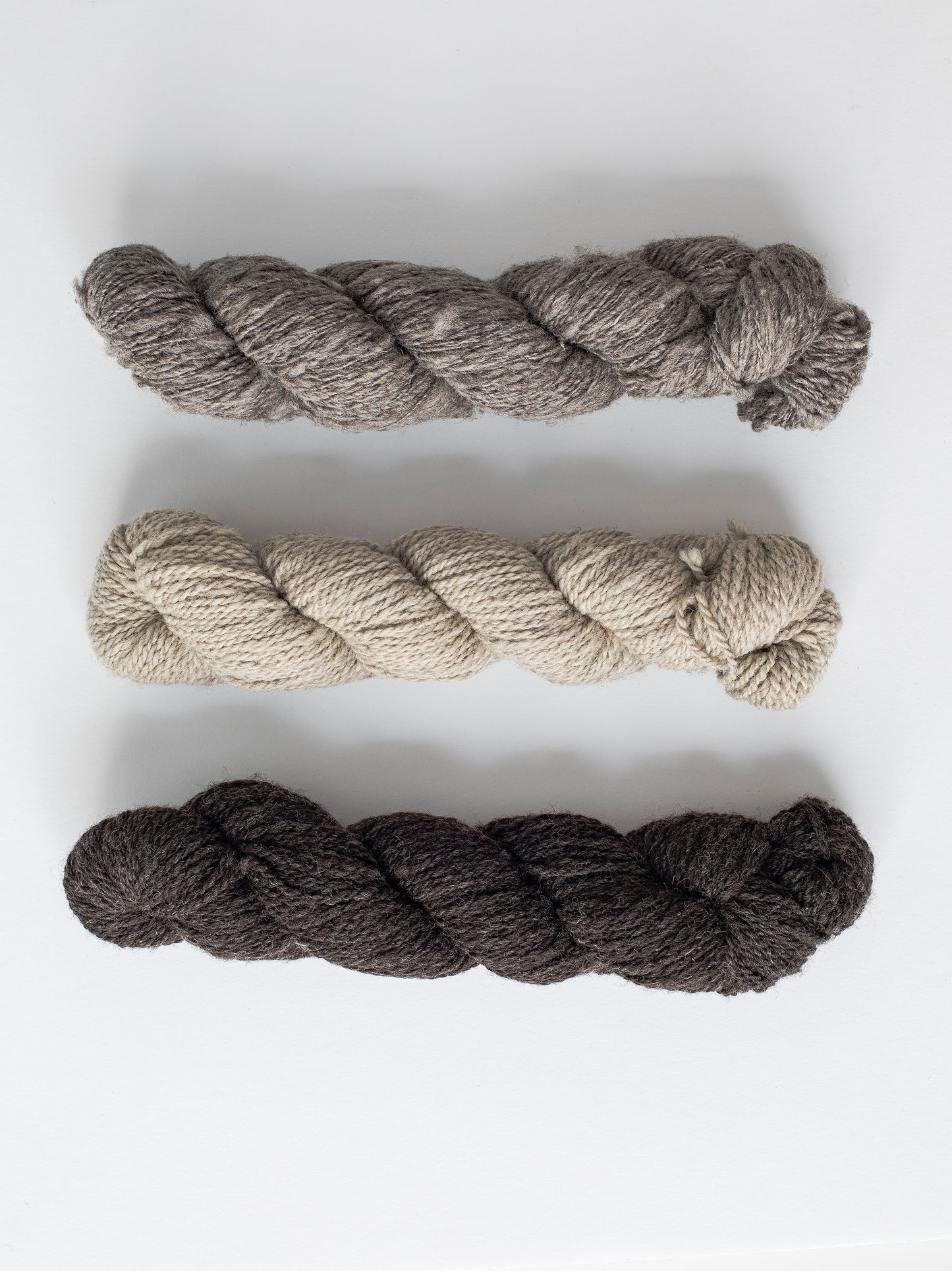 Natural, un-dyed wool yarn in Cream, Light Grey, & Dark Grey colors, each skein is 120 yards (109.7 meters), sourced from Jacob sheep raised in California.