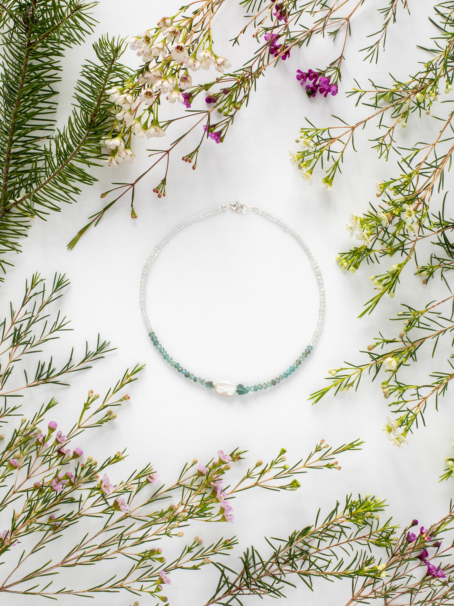 One-of-a-kind statement choker necklace lovingly designed & handmade in California with Apatite, Aquamarine, Freshwater Pearl, Quartz, & Sterling Silver clasp. Rooted in encouraging holistic energy, this necklace is designed to unite the Sacral, Solar Plexus, Heart, Throat, Third Eye, & Crown Chakras.