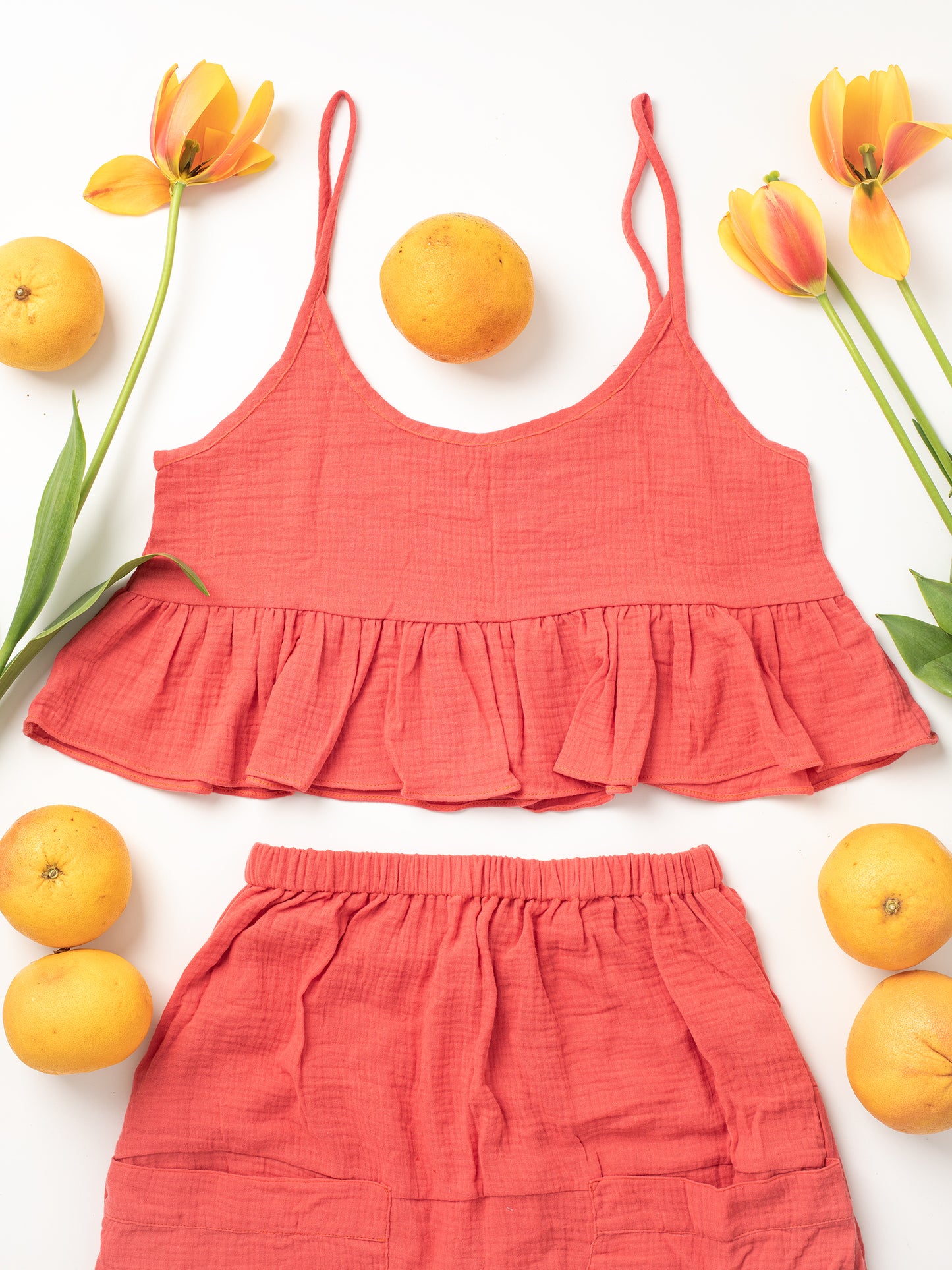 Fun Time Top in Coral Pink - Comes in 6 different colors: Sky Blue, Sage Green, Lavender Purple, Bright White, Golden Yellow, Desert Taupe, Coral Pink, & Jet Black, Easy fit designed to look good on any shape or size, XS, S, M, L, XL, 100% Organic Cotton Double Gauze. Designed & Made in California.