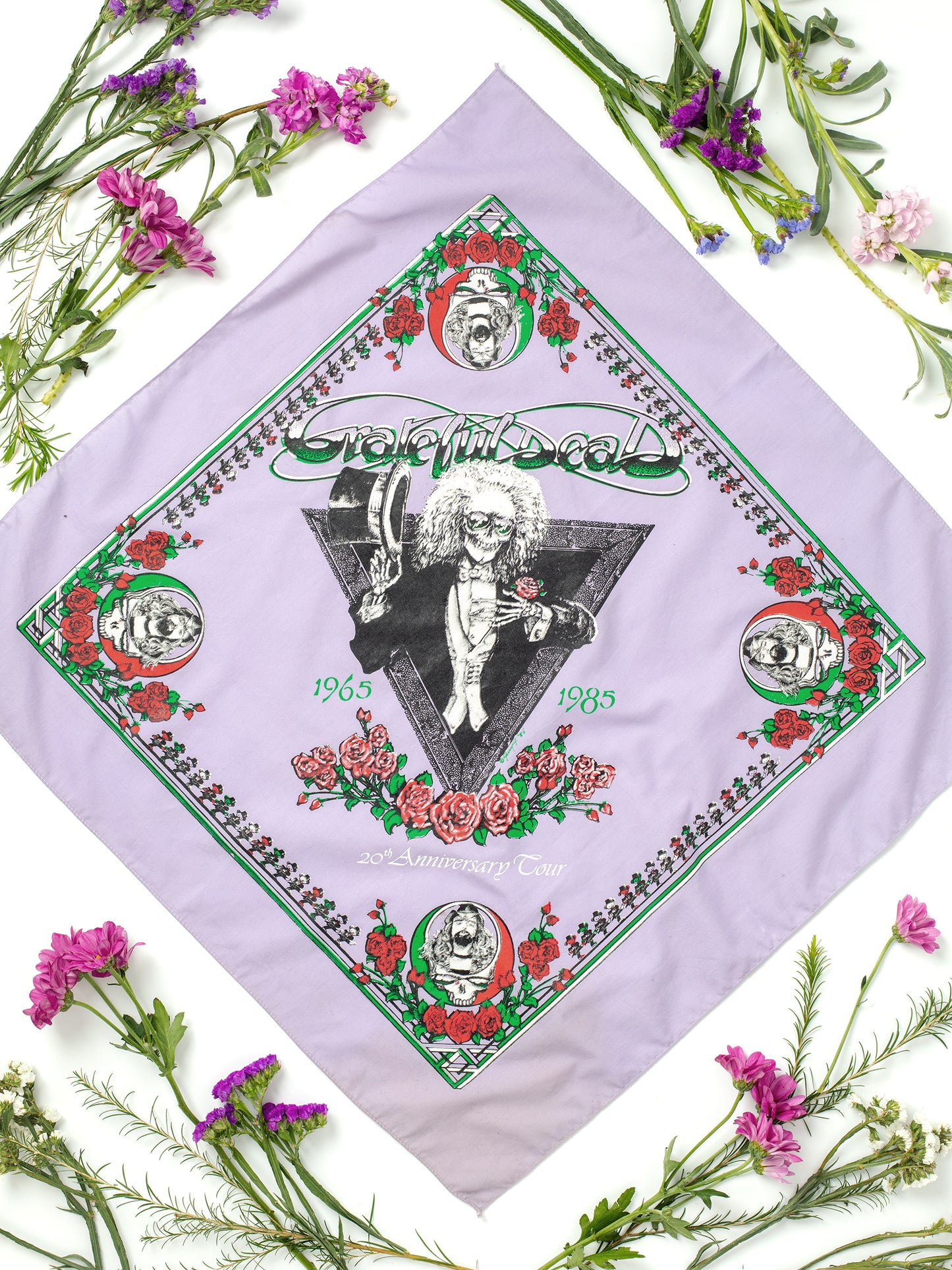 Vintage Purple Cotton Grateful Dead 20th Anniversary Tour Bandana Featuring Pigpen (1980s), Lavender Purple color fabric w/ Red, Green, White, & Black screen print, Steal Your Face logos featuring Pigpen, Cotton, Excellent condition, No holes or tears to note, Sourced in Los Angeles, California.