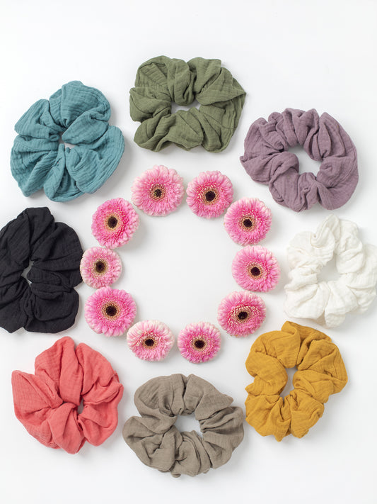 Organic Cotton Double Gauze Scrunchies (Medium Size), Sky Blue, Sage Green, Lavender Purple, Bright White, Golden Yellow, Desert Taupe, Coral Pink, & Jet Black, Colors that match our organic cotton gauze skirts & tops, Medium size, Comfy on the wrist with a 7in diameter of elastic, 100% Organic Cotton Double Gauze, Versatile & soft, limiting possible breakage, Designed & made in California.