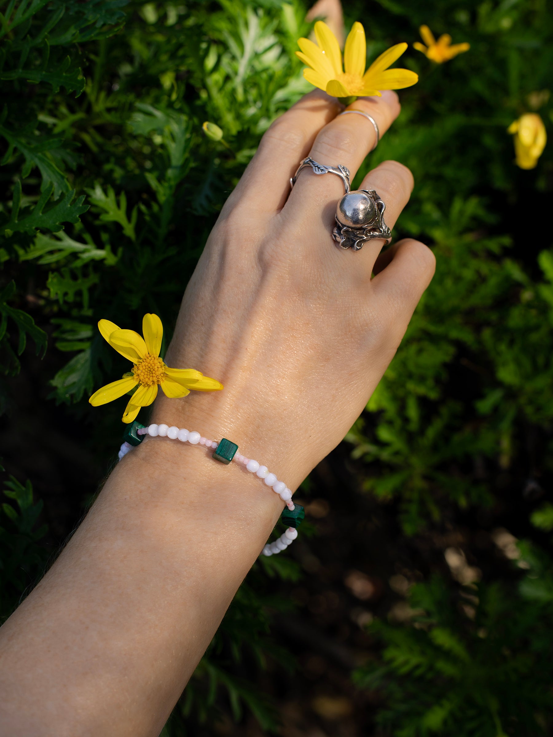 One-of-a-kind natural Pink Coral, Malachite, & Mother of Pearl designer bracelet with sterling silver hardware, designed & handmade in California.