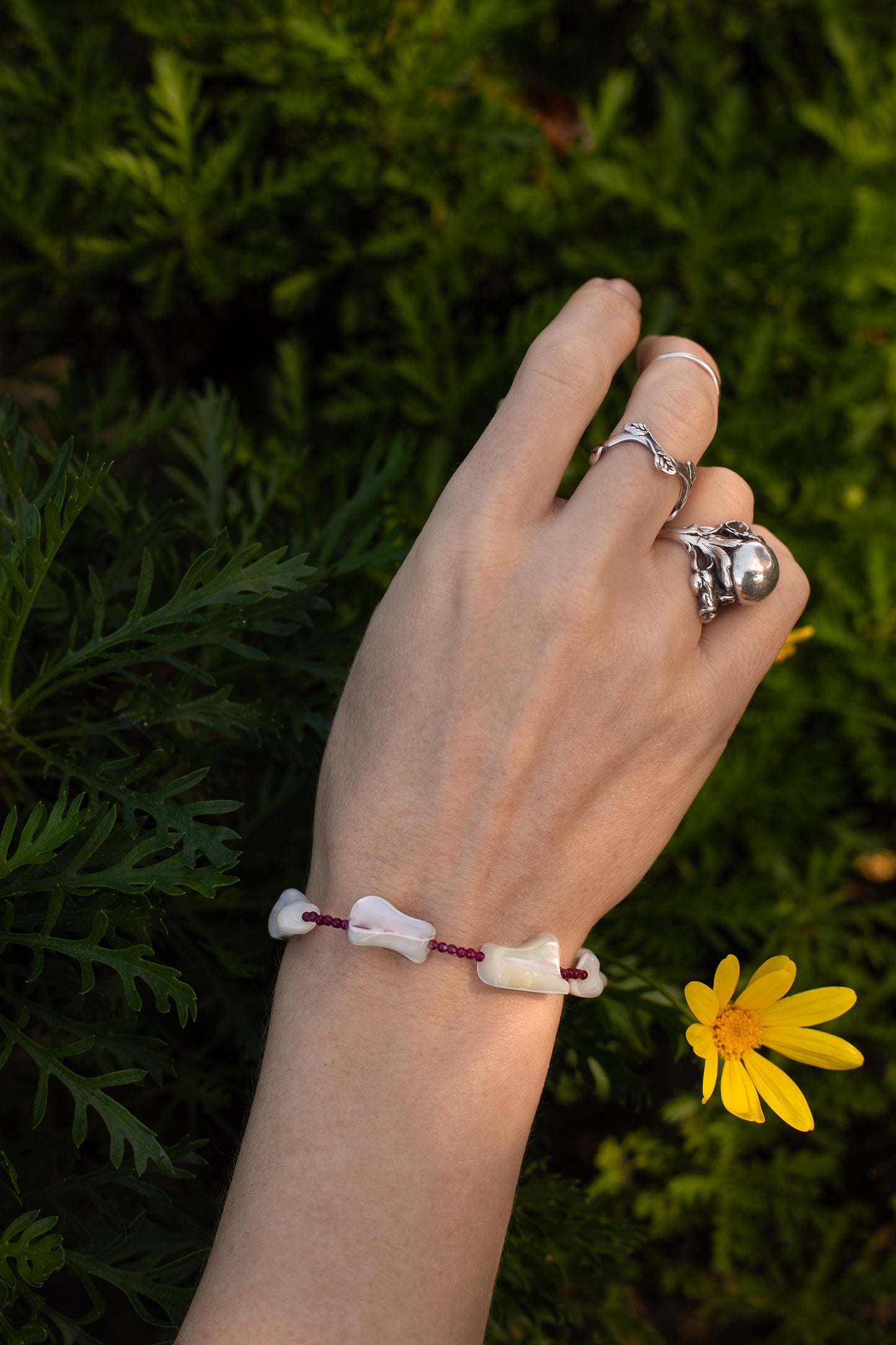 One-of-a-kind natural crystal & shell designer bracelet with sterling silver hardware, designed & handmade in California. Crystals & shells include Red Garnet & Mother of Pearl.