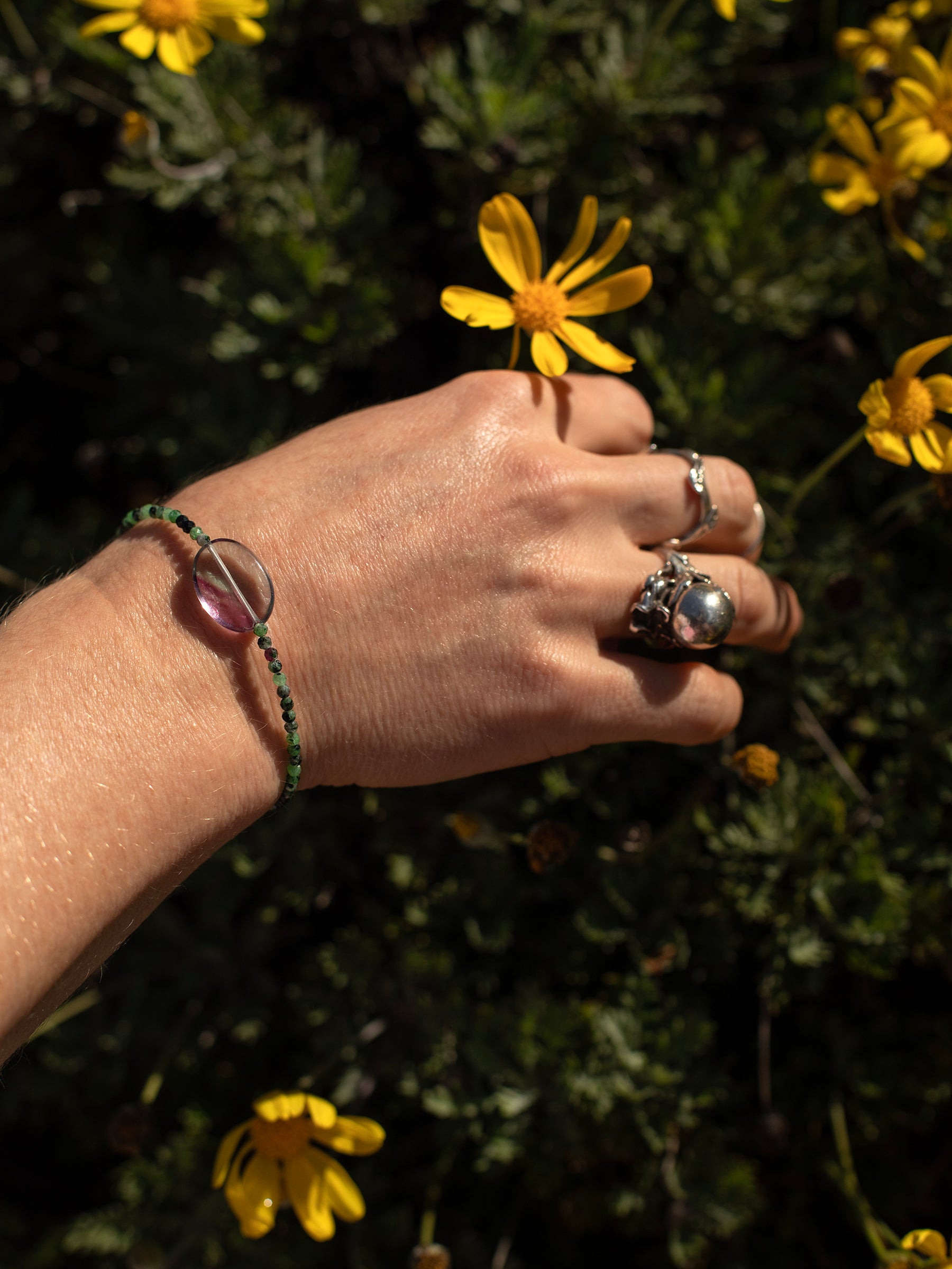 One-of-a-kind natural crystal designer bracelet with sterling silver hardware, designed & handmade in California. Crystals include Purple Fluorite, Rhodonite, & Ruby Zoasite.