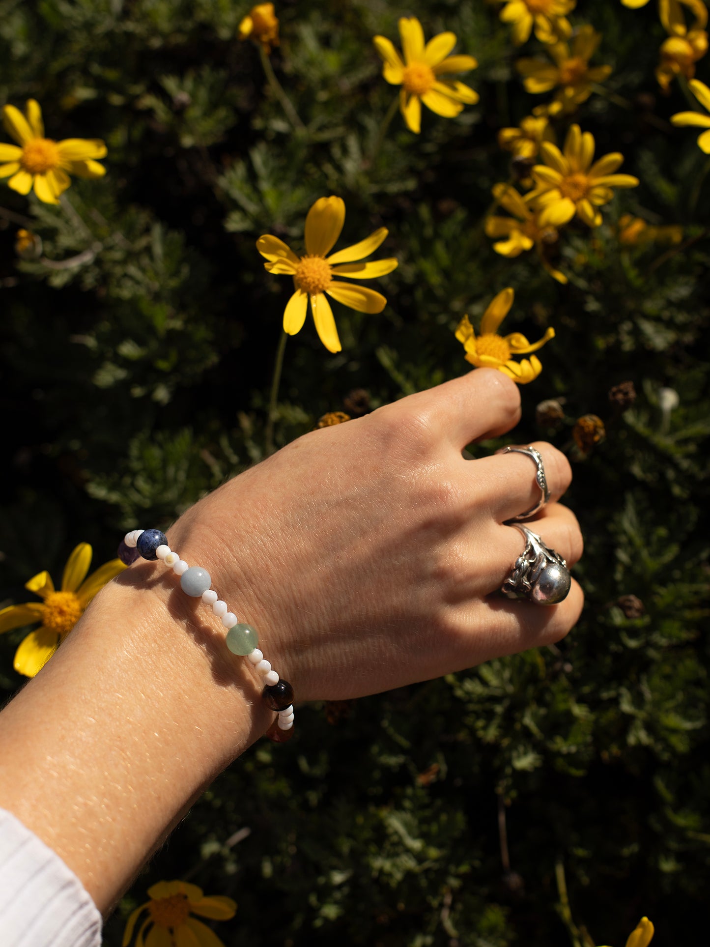 One-of-a-kind natural crystal & shell designer bracelet with sterling silver hardware, designed & handmade in California. Crystals & stones include Amethyst, Aventurine, Blue Lapis, Carnelian, Light Blue Calcite, Mother of Pearl, Red Jasper, and Tiger's Eye.