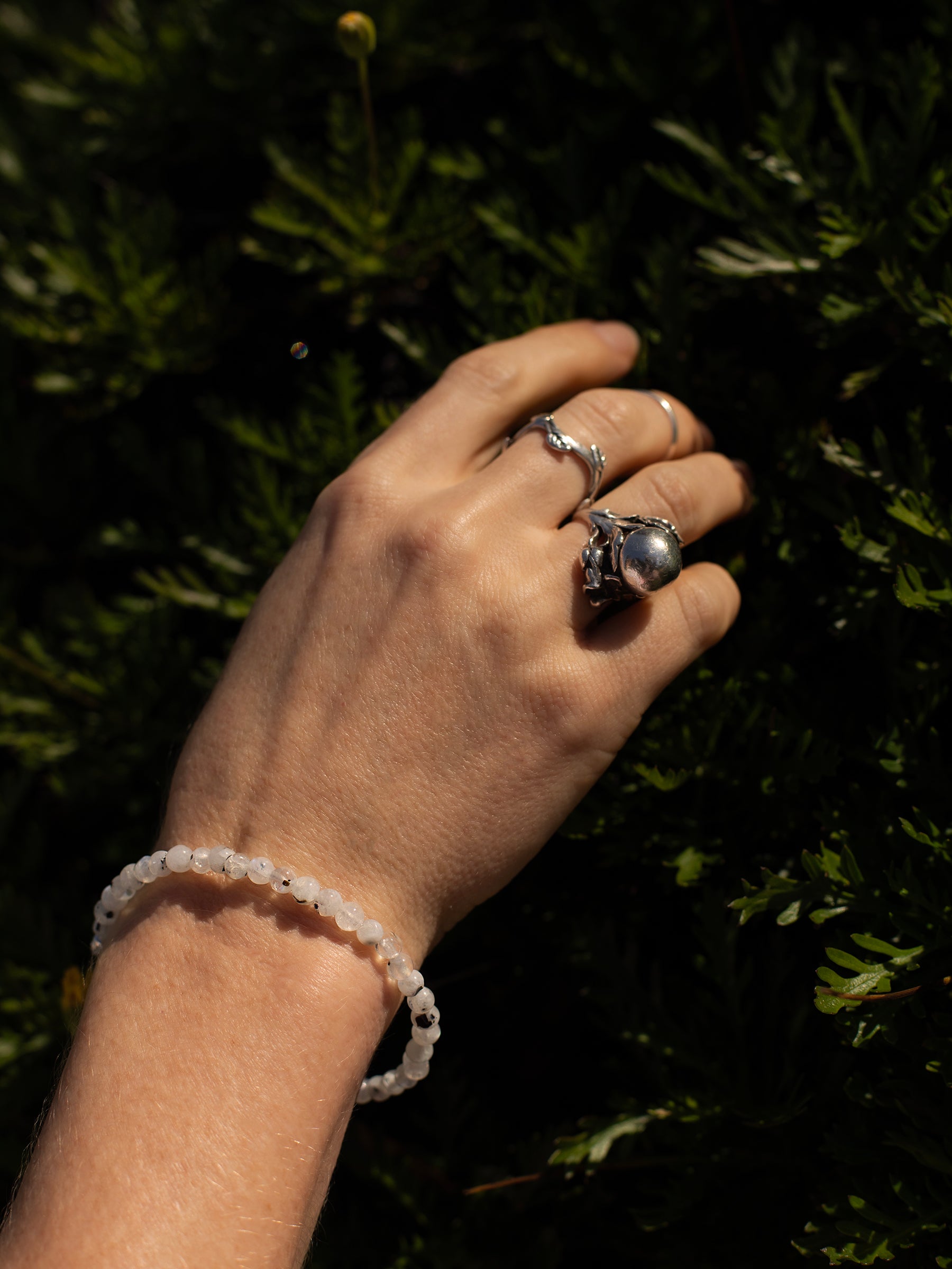 One-of-a-kind natural crystal designer bracelet with sterling silver hardware, designed & handmade in California. Crystals include Black Tourmaline &
Rainbow Moonstone.