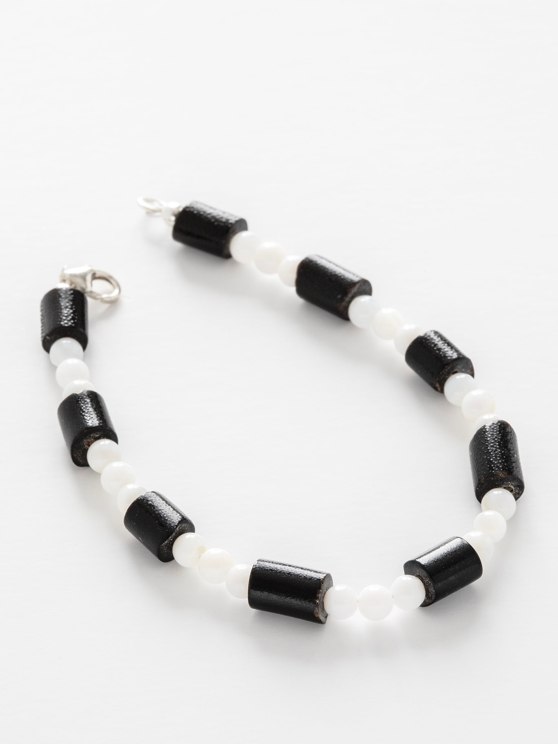 One-of-a-kind natural Black Coral & Mother of Pearl designer bracelet with sterling silver hardware, designed & handmade in California.