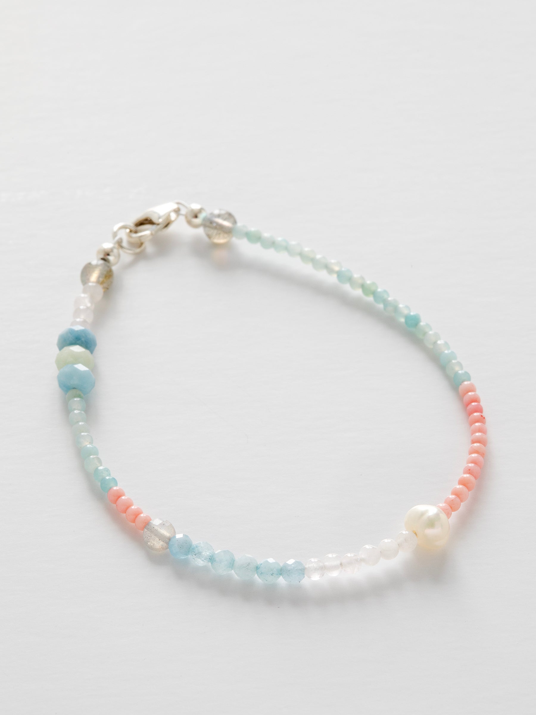 One-of-a-kind natural crystal designer bracelet with sterling silver hardware, designed & handmade in California. Stones are Amazonite, Freshwater Pearl, Labradorite, Morganite, Pink Coral, & Rose Quartz.