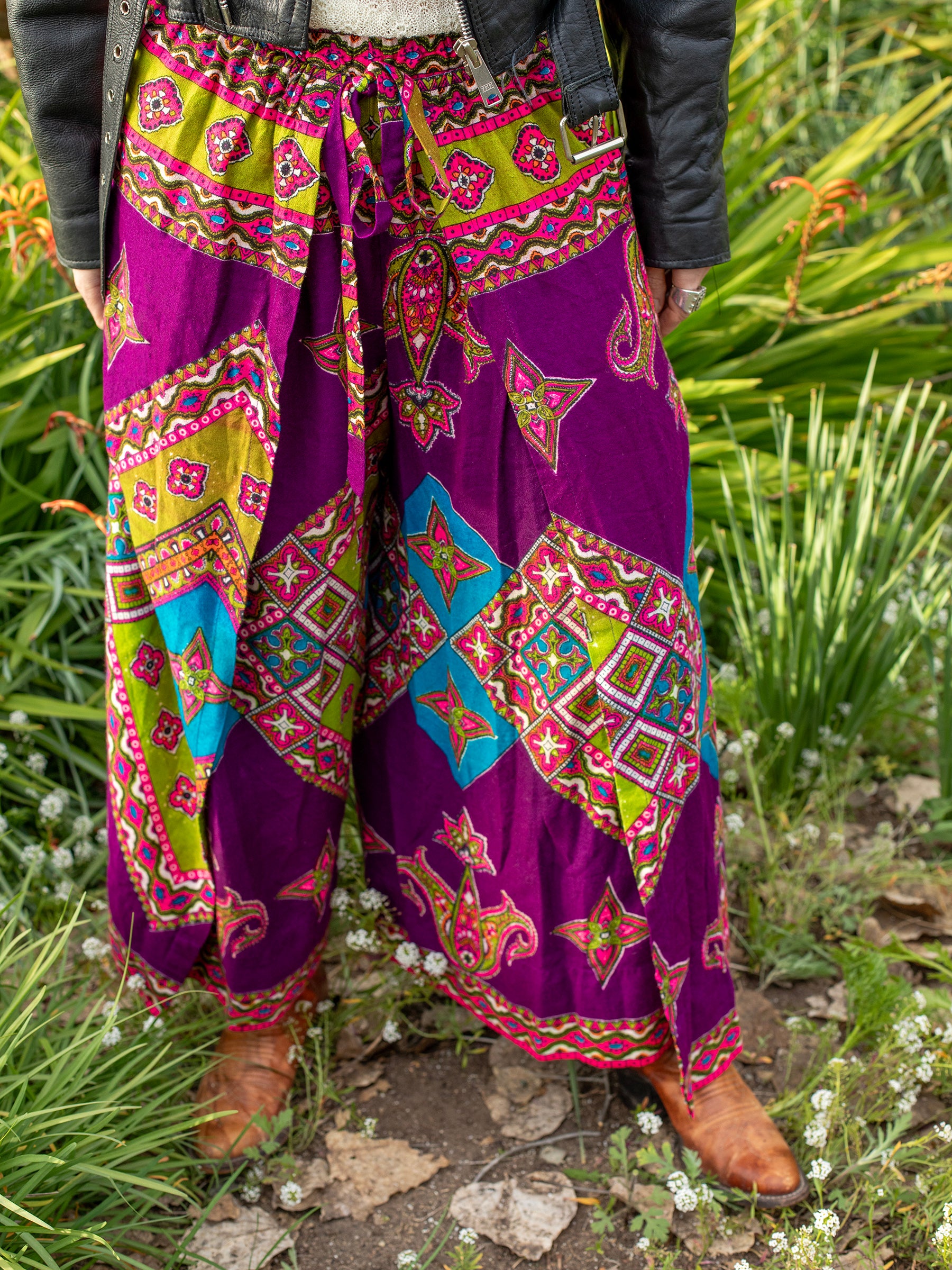 Vintage Psychedelic Purple & Green Paisley Print Tie-Front Palazzo Pants, Cotton-polyester blend fabric is soft, similar to a lightweight flannel, Adjustable tie-front waist, Psychedelic print, 1960s-1970s, Pairs great with a fitted or cropped shirt, vest, or jacket, Sourced in California.