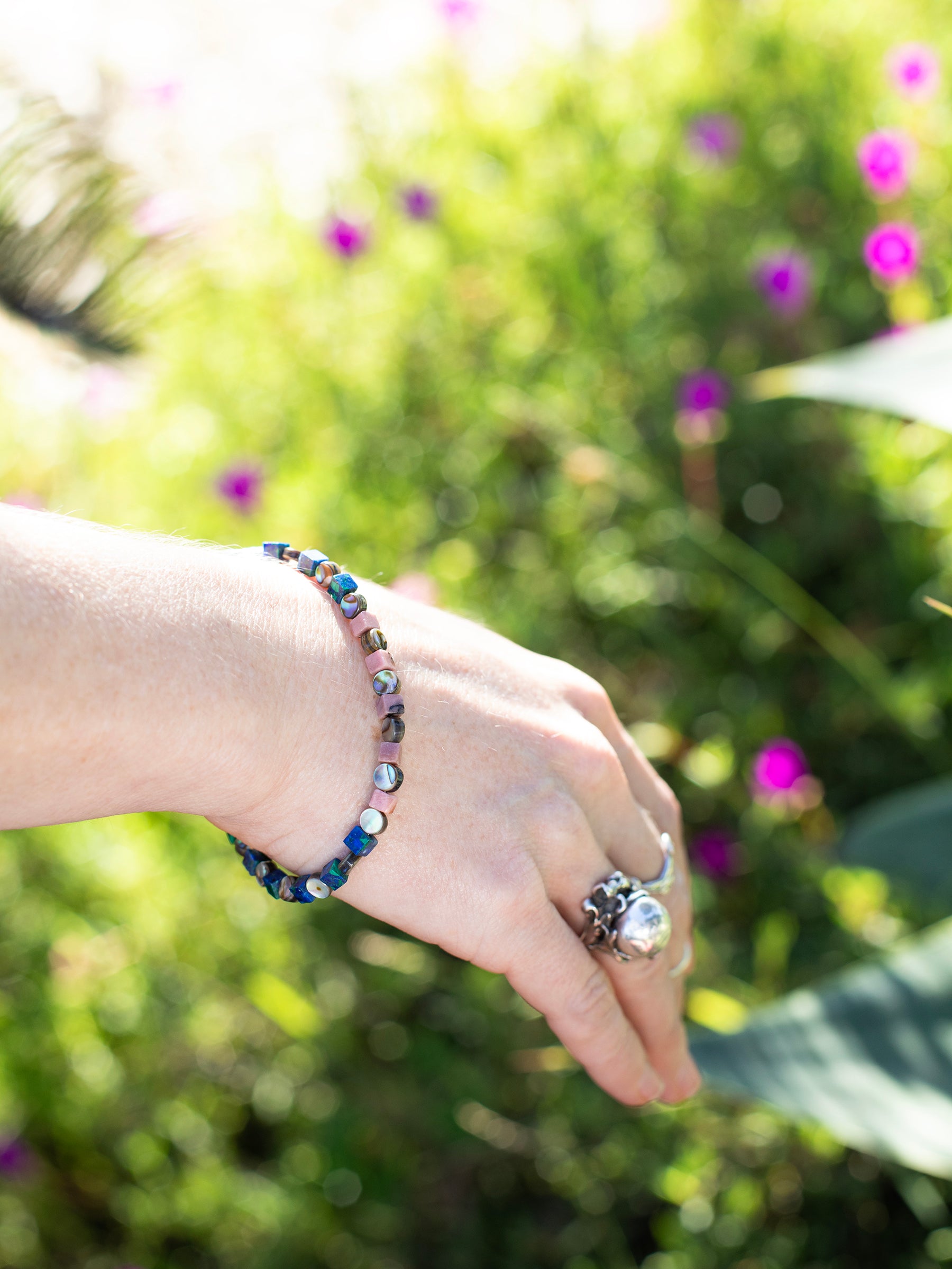 One-of-a-kind natural crystal & shell designer bracelet with sterling silver hardware, designed & handmade in California. Crystals & shells include Abalone, Azurite, Malachite, Rhodonite, & Turquoise.