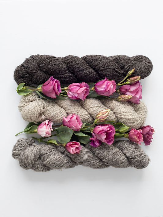 Natural, un-dyed wool yarn in Cream, Light Grey, & Dark Grey colors, each skein is 120 yards (109.7 meters), sourced from Jacob sheep raised in California.