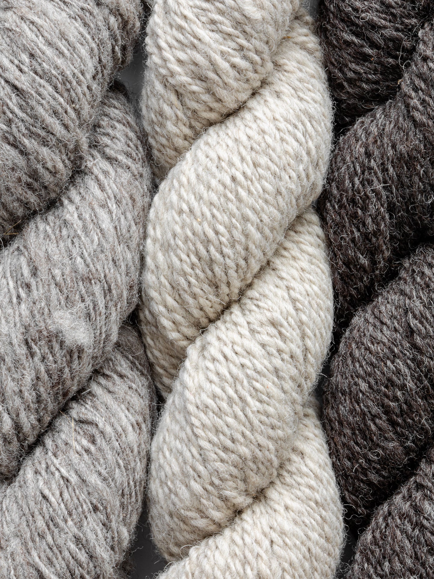 Natural, un-dyed wool yarn in Cream, Light Grey, & Dark Grey colors, each skein is 120 yards (109.7 meters), sourced from Jacob sheep raised in California.