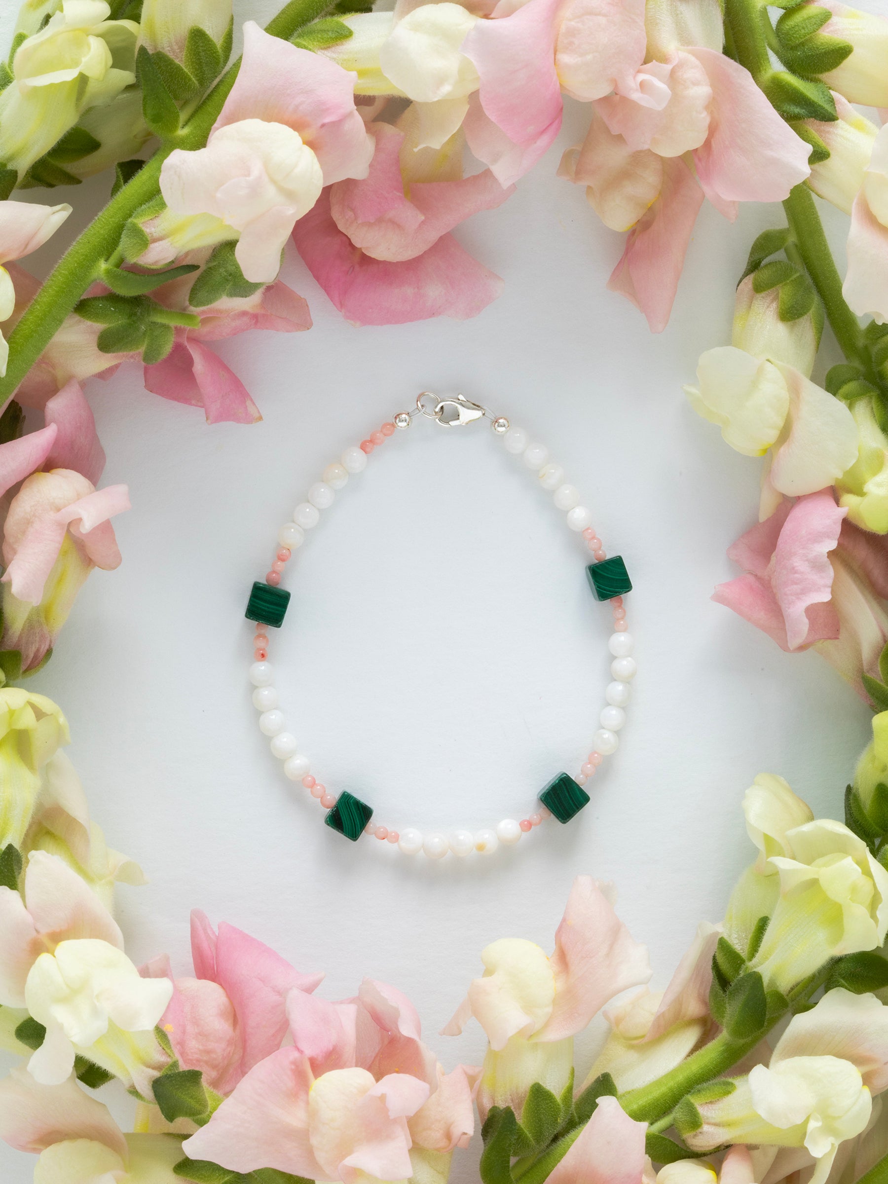 One-of-a-kind natural Pink Coral, Malachite, & Mother of Pearl designer bracelet with sterling silver hardware, designed & handmade in California.