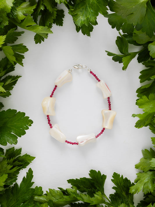 One-of-a-kind natural crystal & shell designer bracelet with sterling silver hardware, designed & handmade in California. Crystals & shells include Red Garnet & Mother of Pearl.