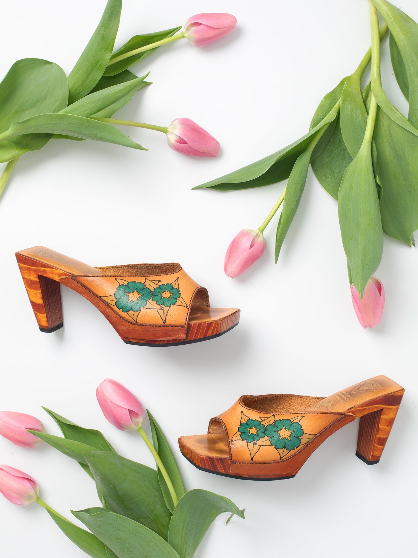Vintage Brown Floral Hand-Painted Leather & Wooden Sandal Heels, Handpainted floral design, Sturdy stacked heel, 1970-1980s, 'John Fluevog Shoes' brand, Wooden sole with black rubber layer on bottom for grip, Leather upper.