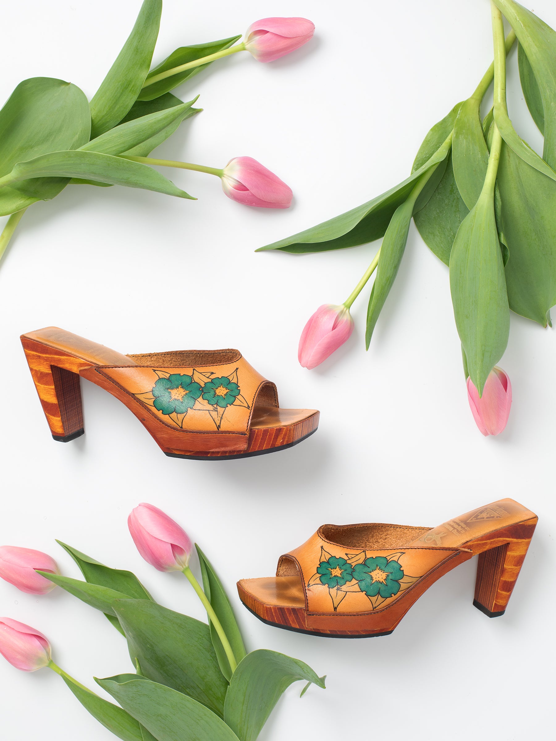 Vintage Brown Floral Hand-Painted Leather & Wooden Sandal Heels, Handpainted floral design, Sturdy stacked heel, 1970-1980s, 'John Fluevog Shoes' brand, Wooden sole with black rubber layer on bottom for grip, Leather upper.