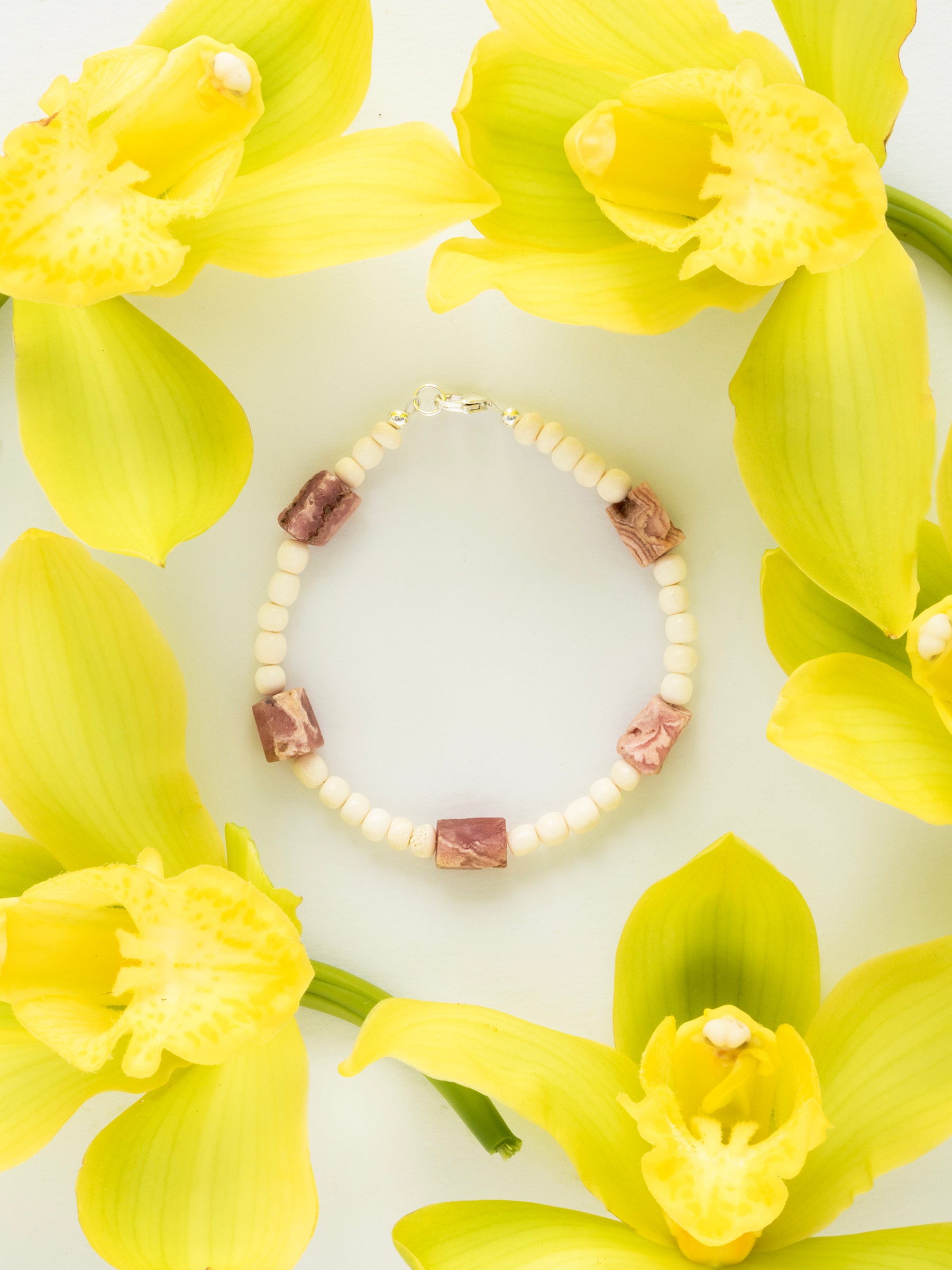 One-of-a-kind natural crystal & cow bone designer bracelet with sterling silver hardware, designed & handmade in California. Crystals are Rhodochrosite.