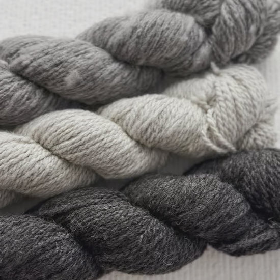 Natural, un-dyed wool yarn in Cream, Light Grey, & Dark Grey colors, each skein is 120 yards (109.7 meters), sourced from Jacob sheep raised in California.