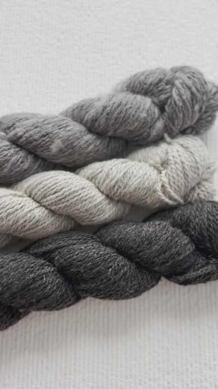 Natural, un-dyed wool yarn in Cream, Light Grey, & Dark Grey colors, each skein is 120 yards (109.7 meters), sourced from Jacob sheep raised in California.