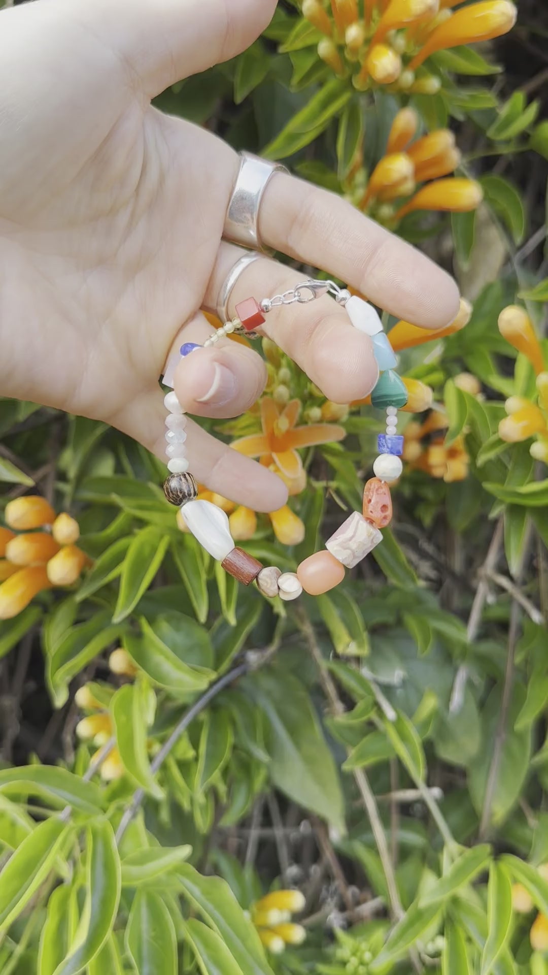 One-of-a-kind natural crystal, stone, & shell designer bracelet with sterling silver hardware, designed & handmade in California. Crystals, stones, & shells include African Opal Jasper, Antique Mediterranean Red Coral, Blue Lapis, Blue Opal, Buri Seed (from the Buri Palm tree), Coconut Shells, Freshwater Pearl, Malachite, Morganite, Mother of Pearl, Natural Shells, Pink Coral, Rhodochrosite, & Rose Quartz.