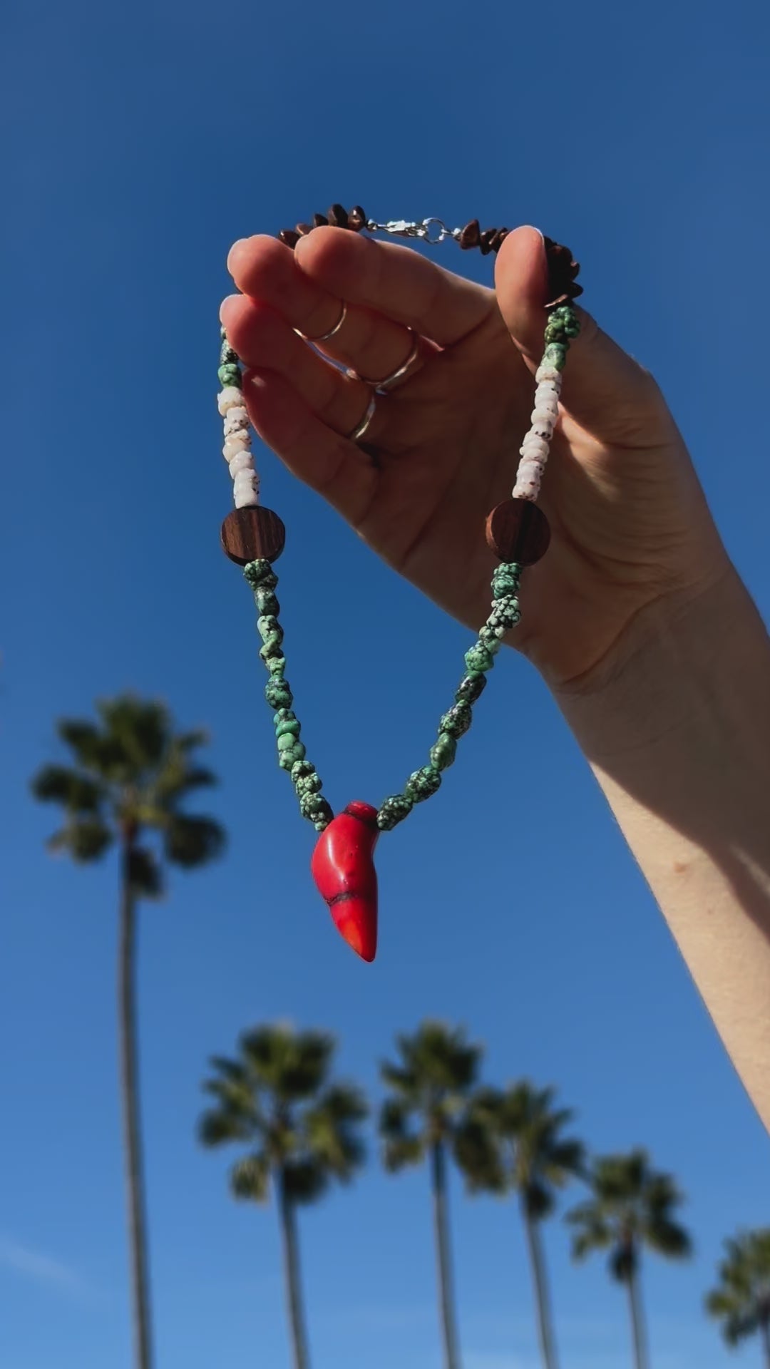 One-of-a-kind natural stone, shell, & wood designer bracelet with sterling silver hardware, designed & handmade in California. Stones & shells include Coconut Shells, Natural Puka Shells, Red Coral, & Turquoise.