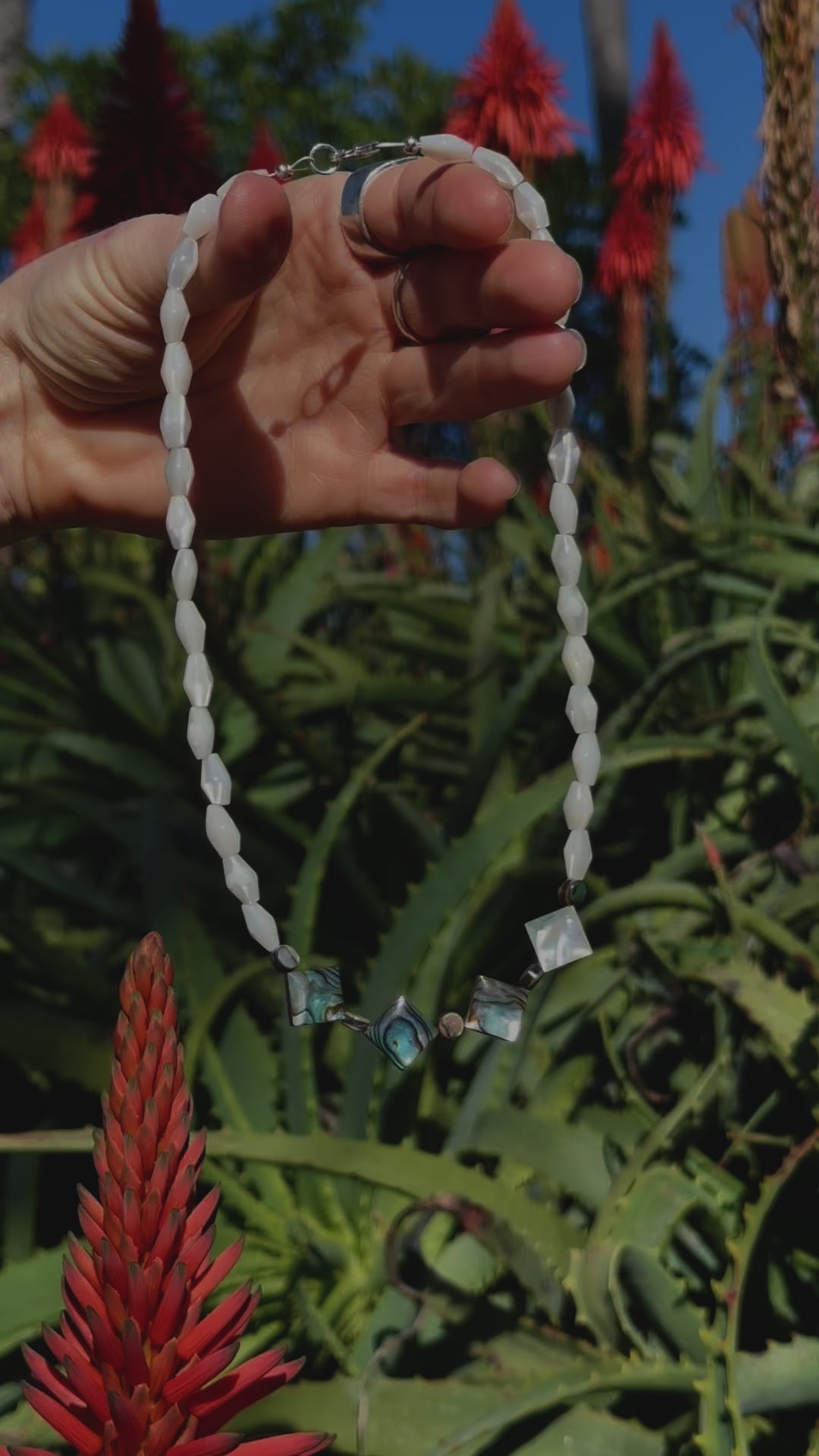 One-of-a-kind natural shell designer necklace with sterling silver hardware, designed & handmade in California. Shells include Mother of Pearl & Abalone.