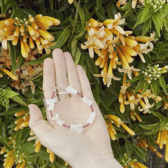 One-of-a-kind natural crystal & shell designer bracelet with sterling silver hardware, designed & handmade in California. Crystals & shells include Red Garnet & Mother of Pearl.