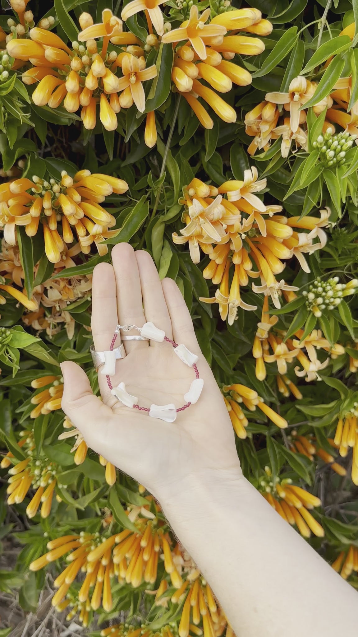 One-of-a-kind natural crystal & shell designer bracelet with sterling silver hardware, designed & handmade in California. Crystals & shells include Red Garnet & Mother of Pearl.