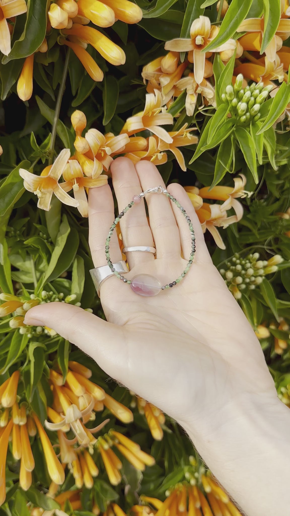 One-of-a-kind natural crystal designer bracelet with sterling silver hardware, designed & handmade in California. Crystals include Purple Fluorite, Rhodonite, & Ruby Zoasite.