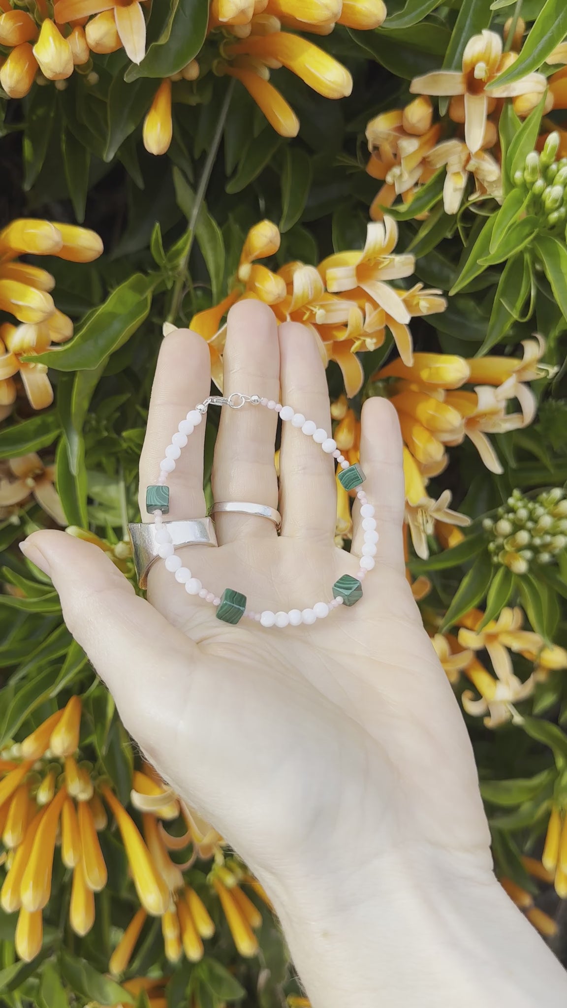 One-of-a-kind natural Pink Coral, Malachite, & Mother of Pearl designer bracelet with sterling silver hardware, designed & handmade in California.